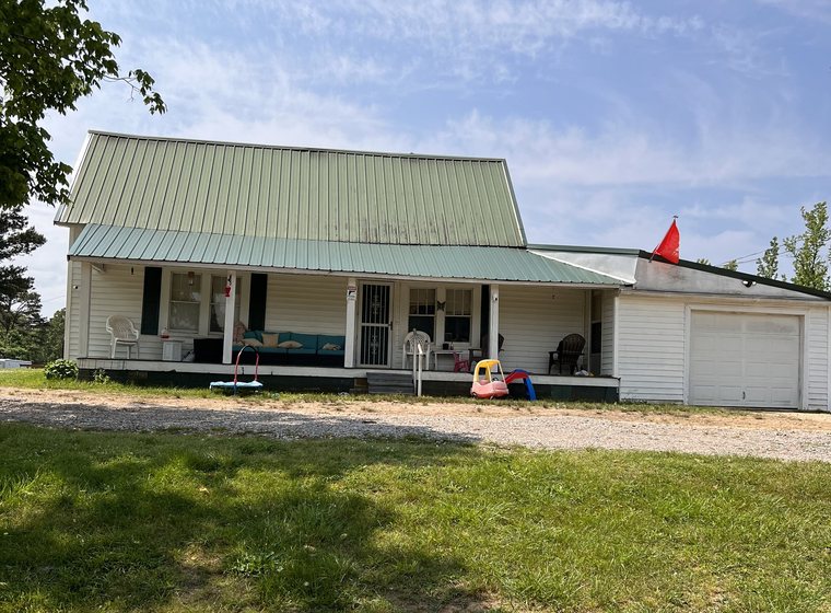 The farmhouse and attached garage in summer