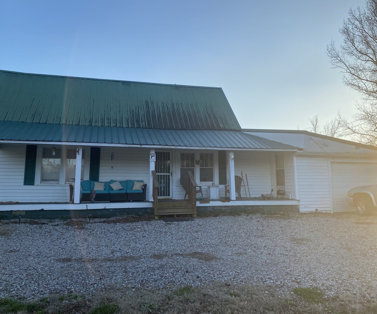 The 1920 farmhouse at Ivy Rose Ranch at golden hour